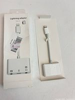 Front of box beside adapter tray