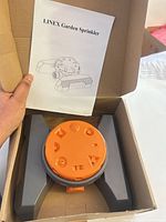 Sprinkler in box with instruction manual