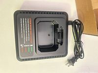 Top view of charger showing battery slot, indicator LEDs, attached cord