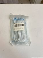 Front of sealed Livinting package showing cable coiled inside and barcode label