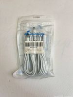 Front of sealed Liwinting package showing two white cables and barcode label