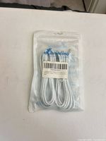Front of sealed Liwinting pouch showing coiled white cable