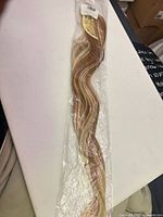 Hairpiece in clear package full view