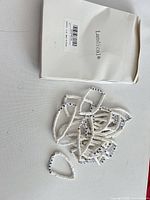 Box marked Landicca and pile of white cheer bracelets