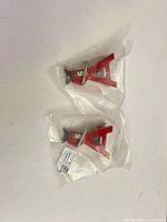 Both red A-shaped parts in sealed bags, top view