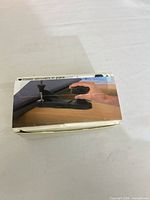 sealed box showing photo of mounting knob in use