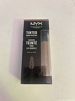 Front of boxed NYX Tinted Brow Mascara showing product window and branding