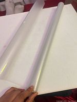 Two rolls of translucent pearlescent vinyl wrap on table