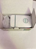 open carton showing one white power factor saver inside