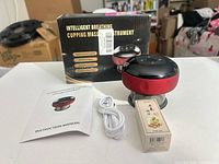 Device, oil box, USB cable, manual and packaging on table