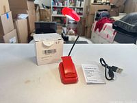 Lamp assembled with box, cable and manual visible