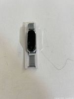 Front view of silver Milanese loop band with black tracker module