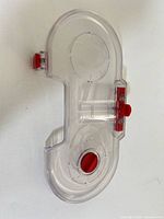 Front view of clear plastic dustbin showing red latch and port openings