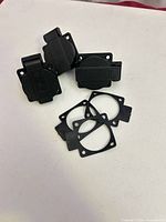 Front view of three sockets with caps closed and three gaskets