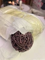Wrapped bundle with one wicker ball visible
