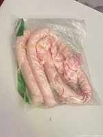 front view of sealed package showing curling rod and scrunchies