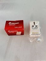 Converter in plastic wrap beside retail box