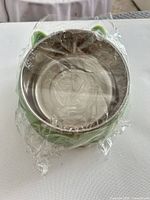 Front view of wrapped small green pet bowl with stainless interior