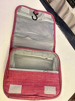 Bag opened displaying compartments and hook