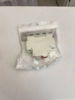 Sealed pouch front with breaker and DIN rail visible