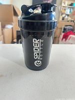 Front view of assembled black Spider Bottle shaker