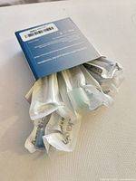 Opened box revealing eight individually wrapped brush heads
