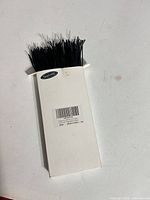 Front view of white TangYinRD box filled with black 6-inch cable ties