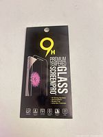 Front of retail package showing 9H Premium Tempered Glass ScreenPro branding