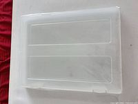 Top view of translucent frosted plastic storage box showing lid and hinges