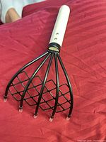 Full view of rake, mesh between tines, wood handle