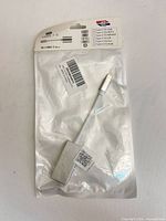 Retail pouch containing silver USB-C to HDMI adapter, front view