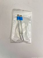 Front of sealed pouch showing two adapters