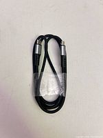 Full view of braided USB-C to USB-C cable coiled
