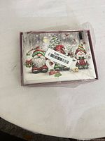 Front view of sealed box showing gnome Santa card design