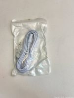 Front view of sealed VoltKare cable showing coiled white cable and connectors