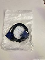 Front view of sealed bag containing VGA cable and warranty card