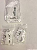 All three packages: outer foil bag and two clear pouches with cables