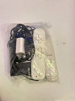 Controller, sensor bar stand, power adapter cable bagged together