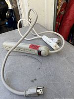 Six-outlet power bar with cord and switch on table