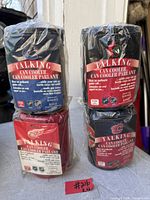 Front view of four sealed talking NHL can coolers stacked two by two, showing team logos and packaging