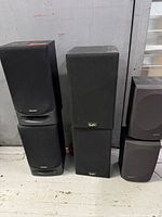 All six speakers grouped in three stacks of two each, showing fronts and brand logos
