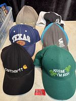 All six baseball caps arranged for visibility of fronts and logos