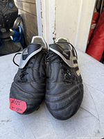 Top view of both cleats showing upper material, laces, branding, overall condition