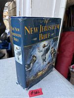 Front and spine view of The New Jerusalem Bible showing dust jacket design and wear