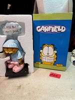 Figurine in foam insert next to original Garfield box