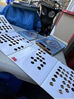 Overview of four fold-out hair colour swatch books on table