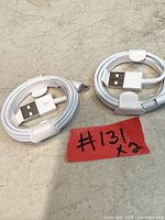 Two coiled white USB-A to micro-USB charging cables with #131 tag