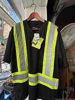 Front view showing reflective stripes, pocket, and tags attached