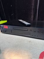 Front angled view of Onkyo CD MP3 player with remote on top