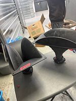 Both horn speakers on table showing shape and size